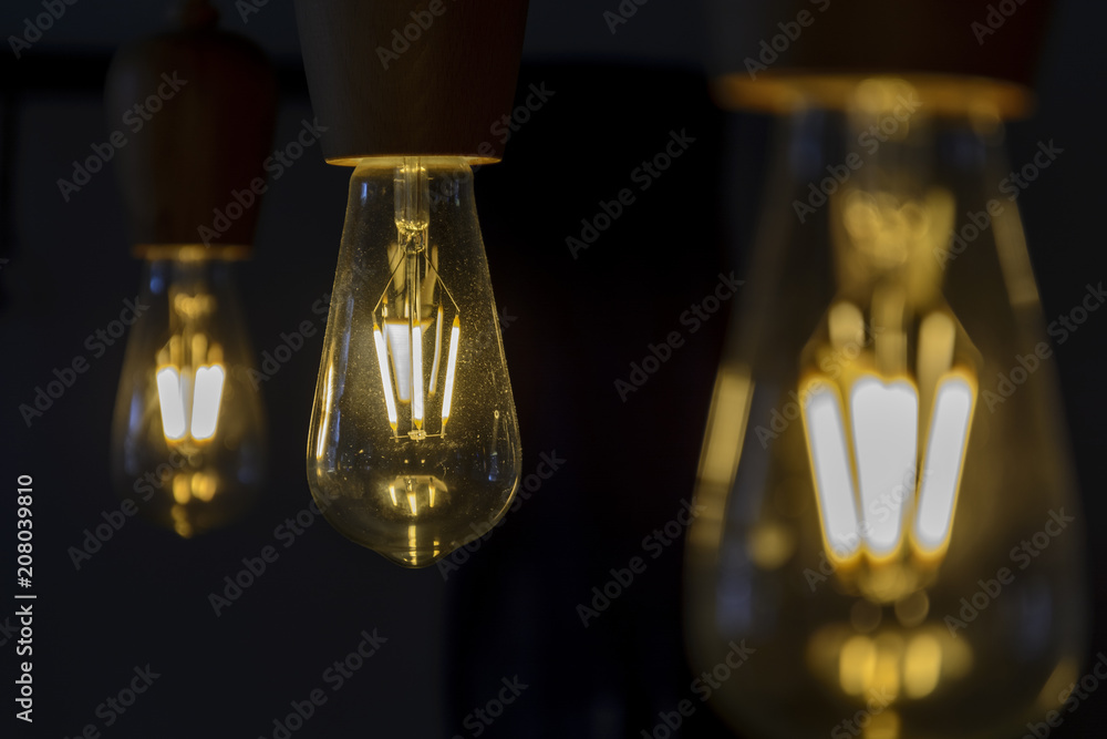 Vintage light bulb close up, lighting bulb in the dark.