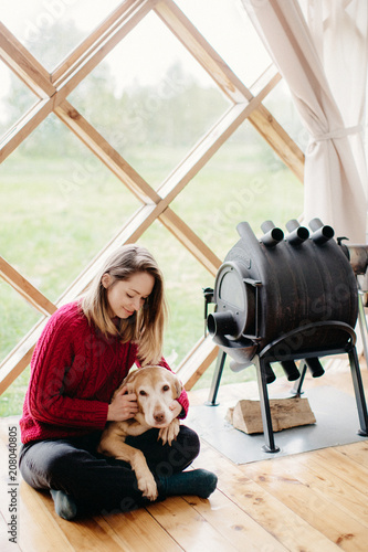 Young woman and a dog relaxing at home photo