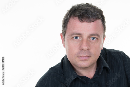 Closeup portrait of middle aged businessman in white office with copy space