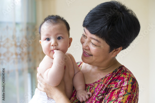 asian grandmother with her baby grandson photo