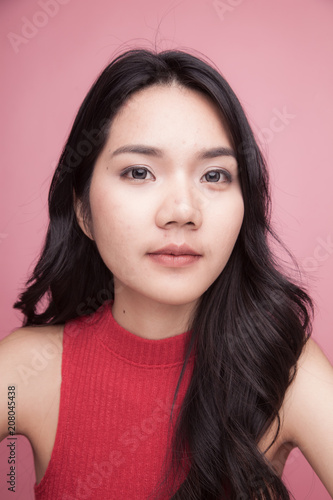 Portrait of beautiful young Asian woman in red shirt