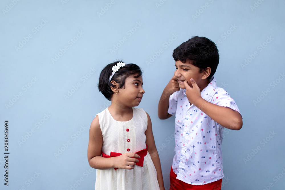 Little girl and her elder brother having fun,happy children Little girl and her elder brother having fun,happy children