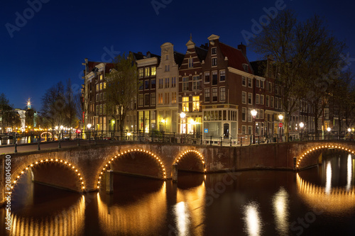 Nachtaufnahme der Ecke Keizersgracht und Leidsegracht in Amsterdam, Niederlande im Frühling.