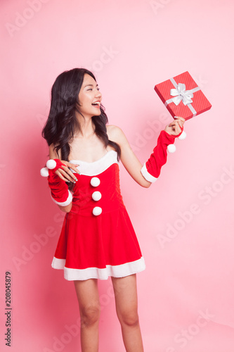Portrait of cute Asian Christmas Santa Claus girl with red gift box