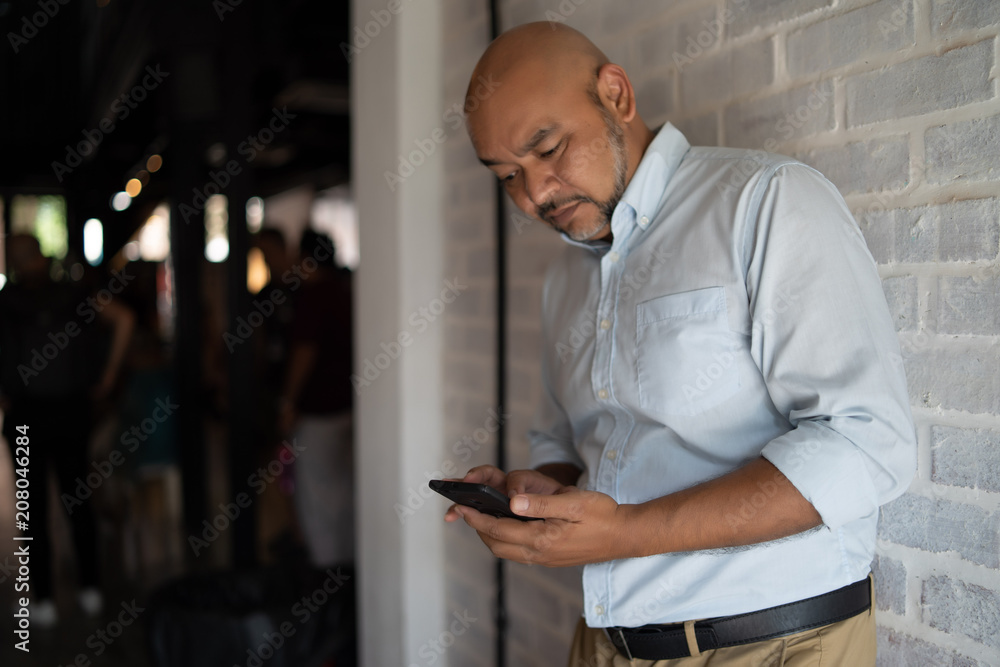Fototapeta premium a man is using his smartphone
