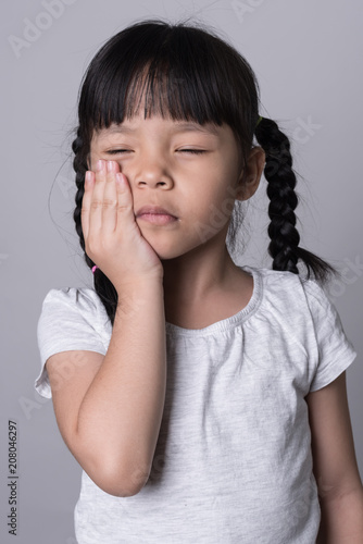 Cute little girl suffering from toothache