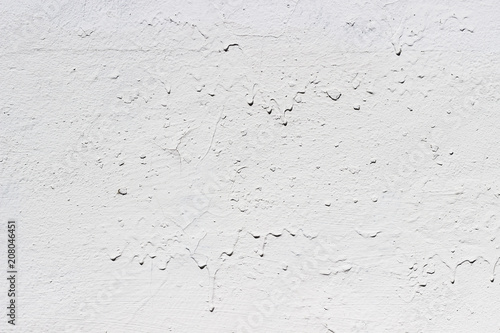 White concrete wall. Drops of paint flow down the wall