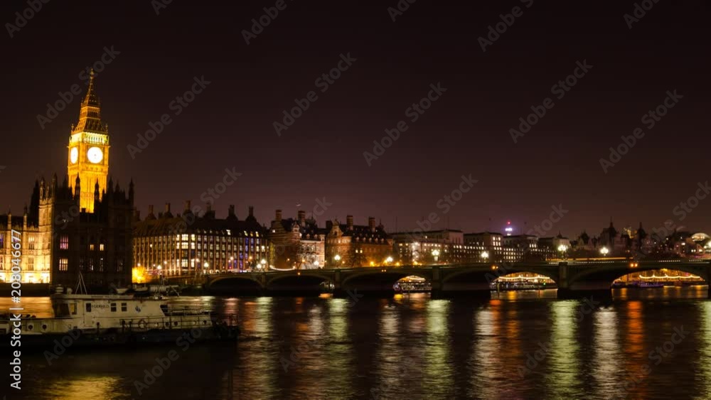 Traffic moves over Westminster Bridge and boats move underneath as the camera pans from south to north bank, revealing Parliament Traffic moves over Westminster Bridge and boats move underneath as the camera pans from south to north bank, revealing Parliament