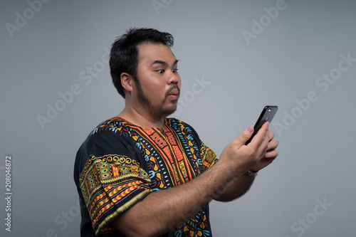 a malay man using a phone © Kencana Studio