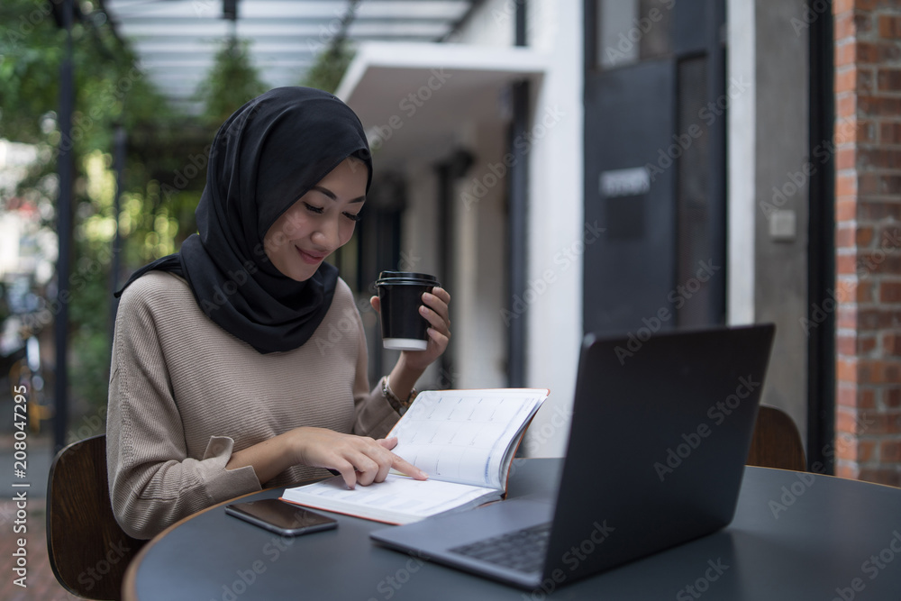 a muslim girl is doing some work a muslim girl is doing some work