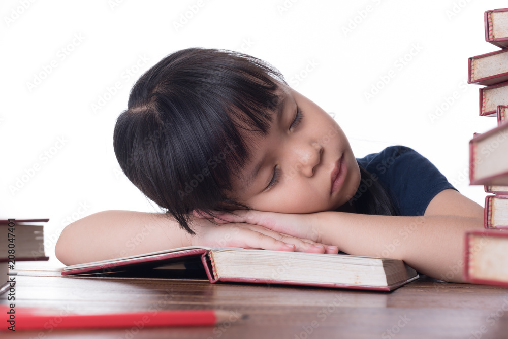 The girl is reading a book at the table. The girl is reading a book at the table.