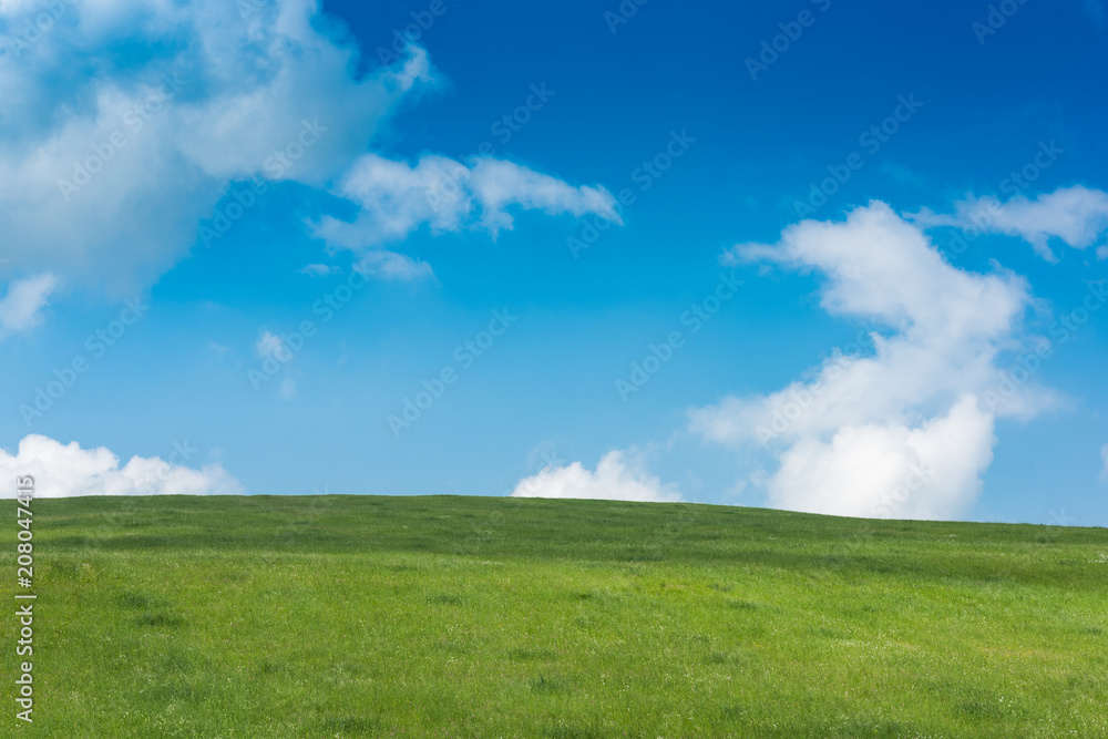 Rolling green hills and blue sky with clouds Rolling green hills and blue sky with clouds