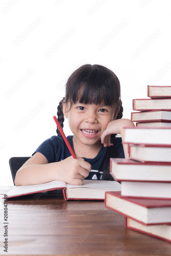 The girl is reading a book at the table. The girl is reading a book at the table.
