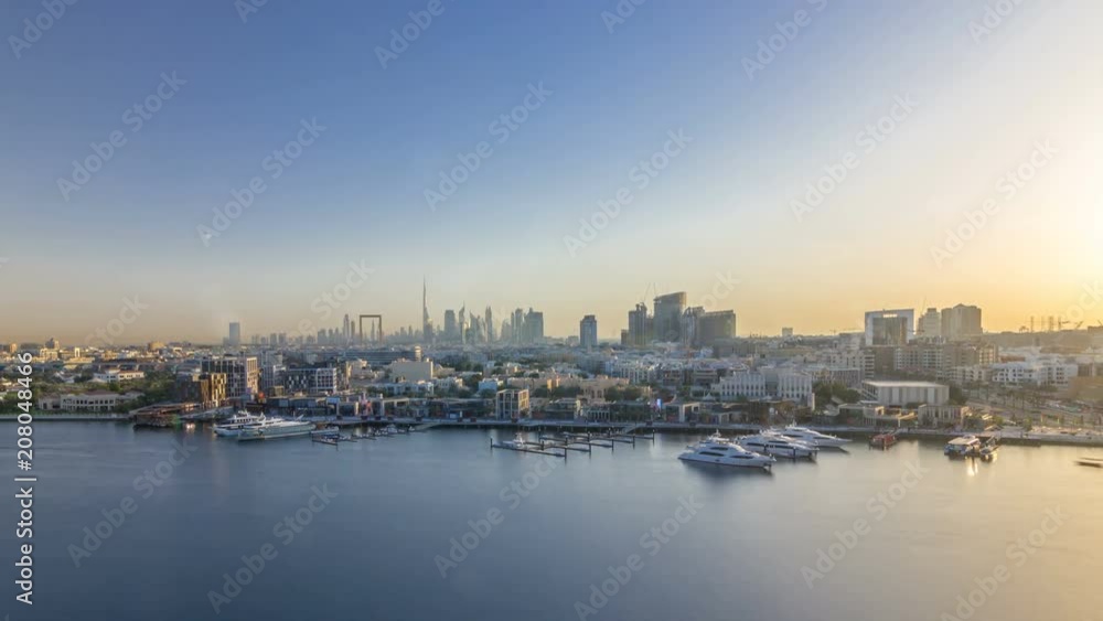 Dubai creek landscape timelapse with boats and ship and modern buildings in the background during sunset Dubai creek landscape timelapse with boats and ship and modern buildings in the background during sunset