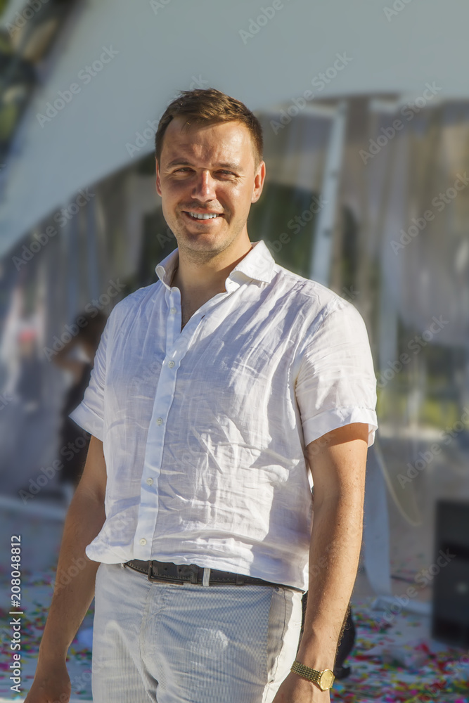 Man with smile standing happy having a good time after party outdoor Man with smile standing happy having a good time after party outdoor