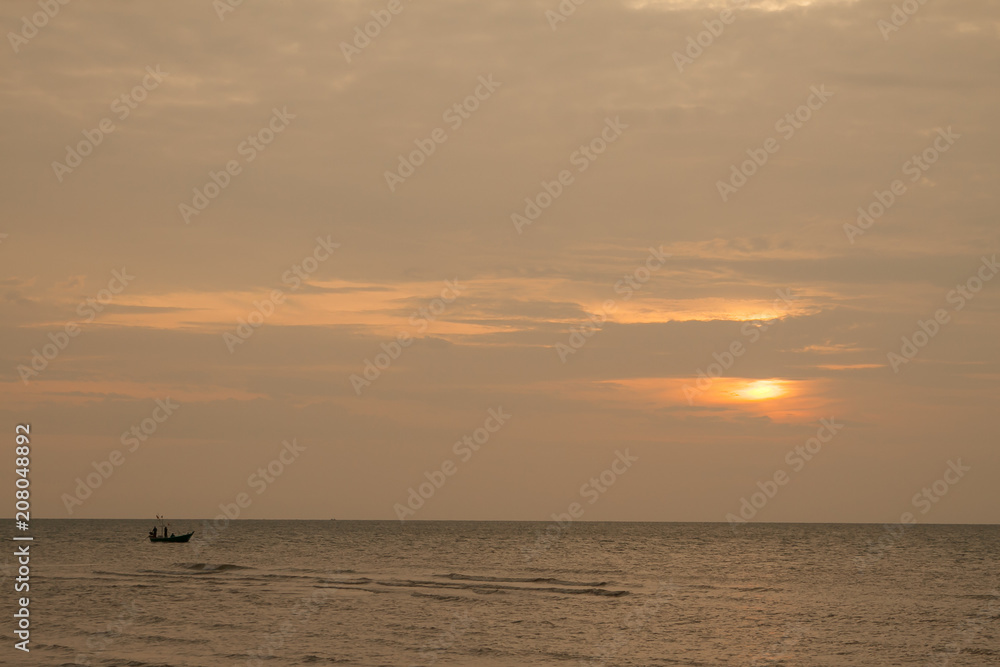 The boat in the sea during the sunset