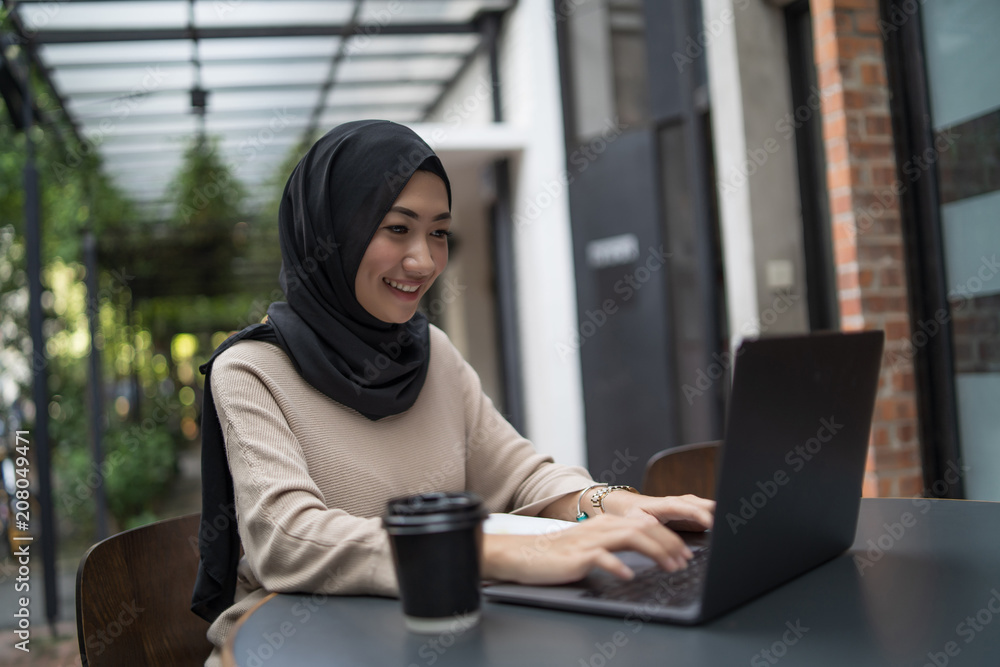 a muslim girl is doing some work a muslim girl is doing some work