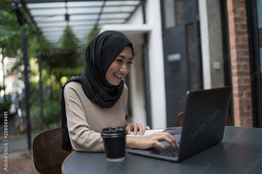 a muslim girl is doing some work a muslim girl is doing some work