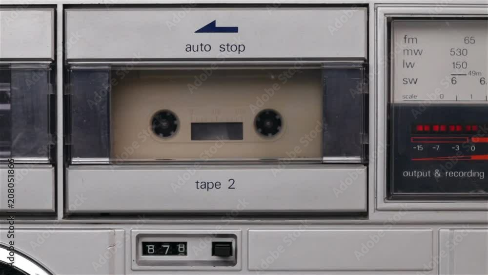 Retro music cassette player playing a compact audio cassette tape - static camera Retro music cassette player playing a compact audio cassette tape - static camera