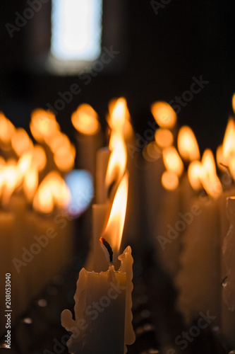 Devotional candles lit inside a church.