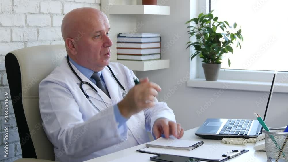 Doctor In Hospital Cabinet Talk With Patient and Write a medical Prescription Doctor In Hospital Cabinet Talk With Patient and Write a medical Prescription