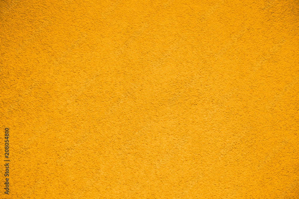 Vivid bright yellow color coarse facade wall as an empty rustic texture background. Vivid bright yellow color coarse facade wall as an empty rustic texture background.