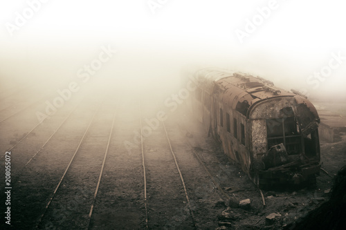 Abandoned rusting train and empty train tracks photographed in misty foggy day in the village Paranapiacaba, Sao Paulo, Brazil. Photo color toned with sepia for surreal and vintage nostalgic look. photo