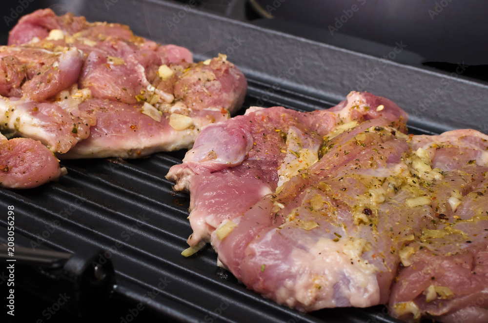 Raw turkey meat on the cooking pan. Preparation of grilled meat.