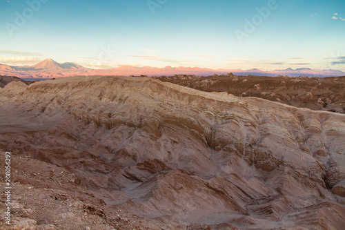 Valle de la Luna (Valley of the Moon) landscape in the Atacama Desert, north of Chile. The wilderness and desolation resembles the surface of Mars or the Moon. Volcano mountains in the background.