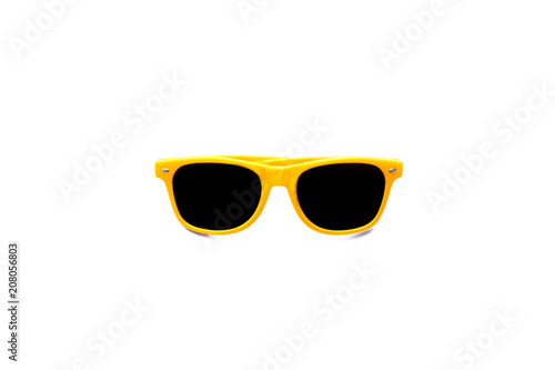Summer yellow sunglasses isolated in large seamless white background. Minimal design element for sun protection, hot days, tropical travel, summer vacations and beach holidays.