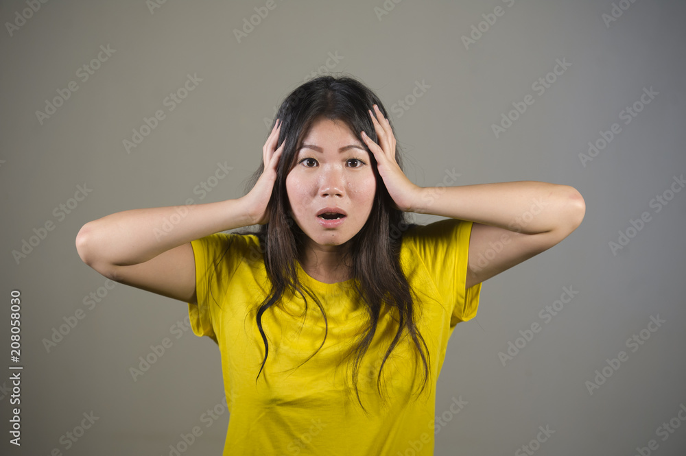 Foto de young sweet and beautiful Asian Korean woman gesturing shocked ...