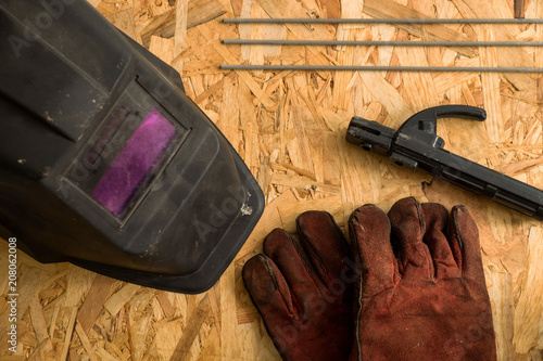 set of  welder tools on wood background . flat lay tools working space for welder , top view. photo