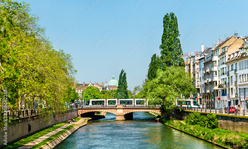 City tram crossing the Ill river in Strasbourg, France