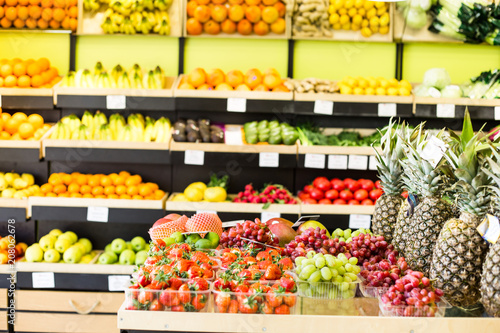 Seasonal and exotic fruits and vegetables on the food shelf in the supermarket