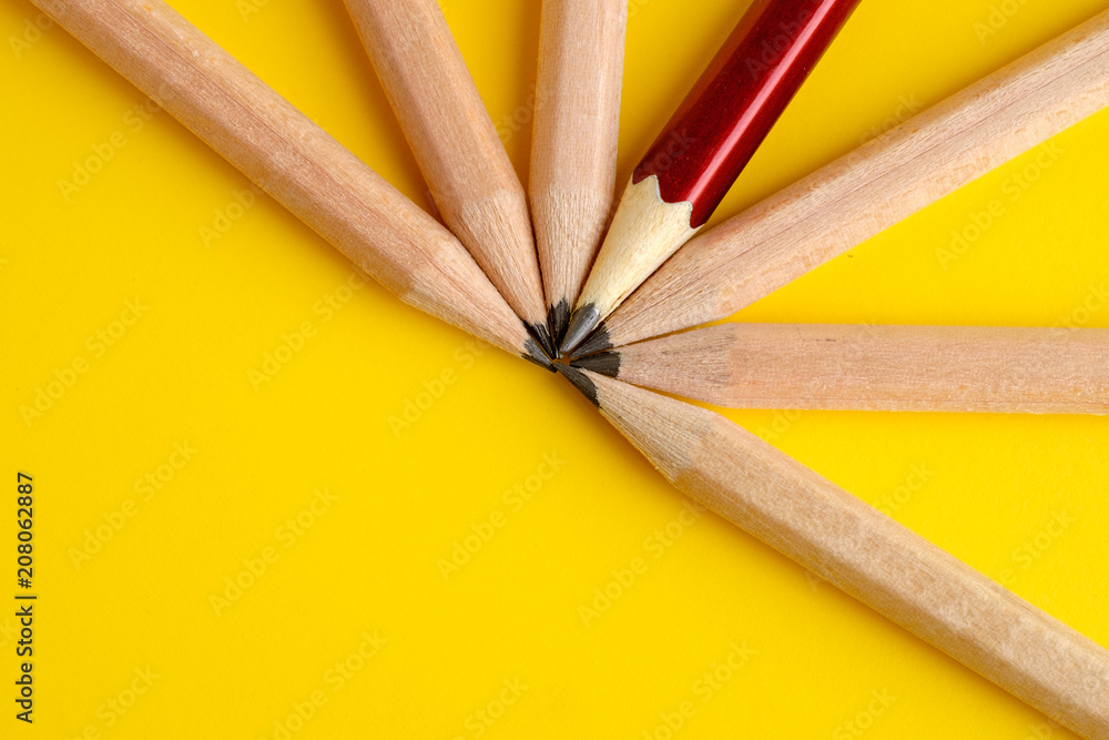 Fototapeta premium Red pencil standing our from the crowd