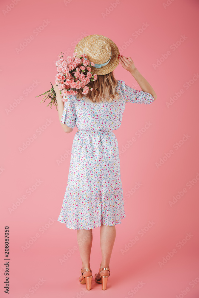 Fototapeta premium Full length back view portrait of a pretty young woman