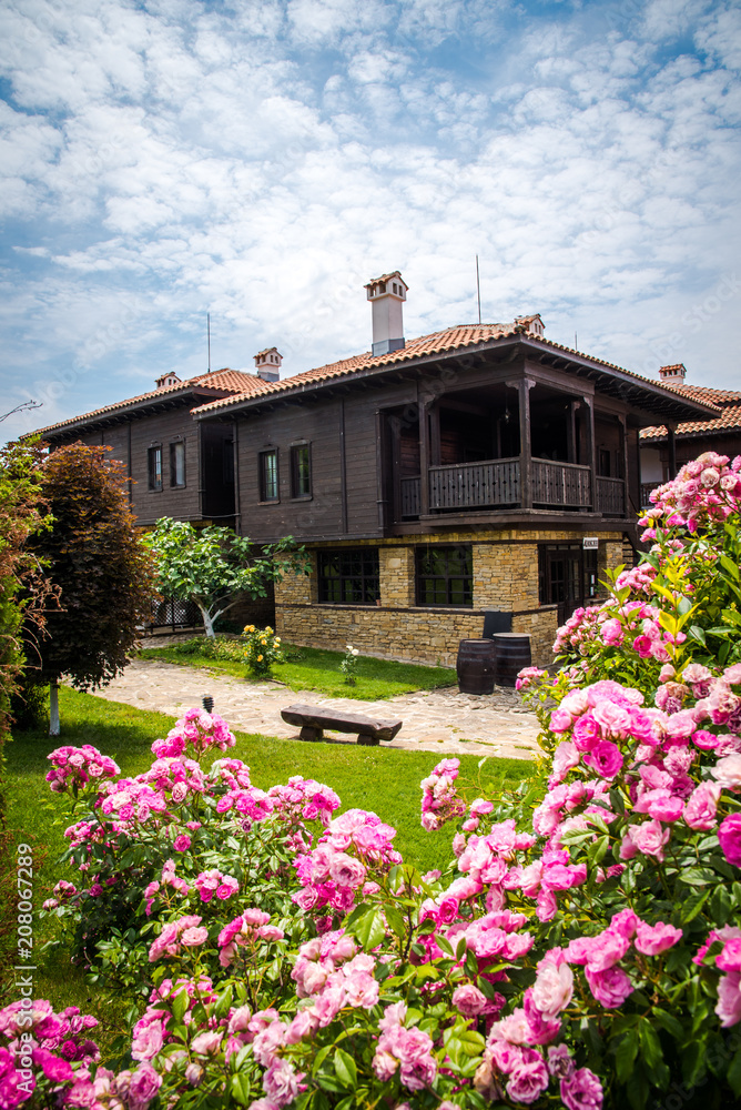 Resort in Bulgaria with traditional rustic houses and green gardens