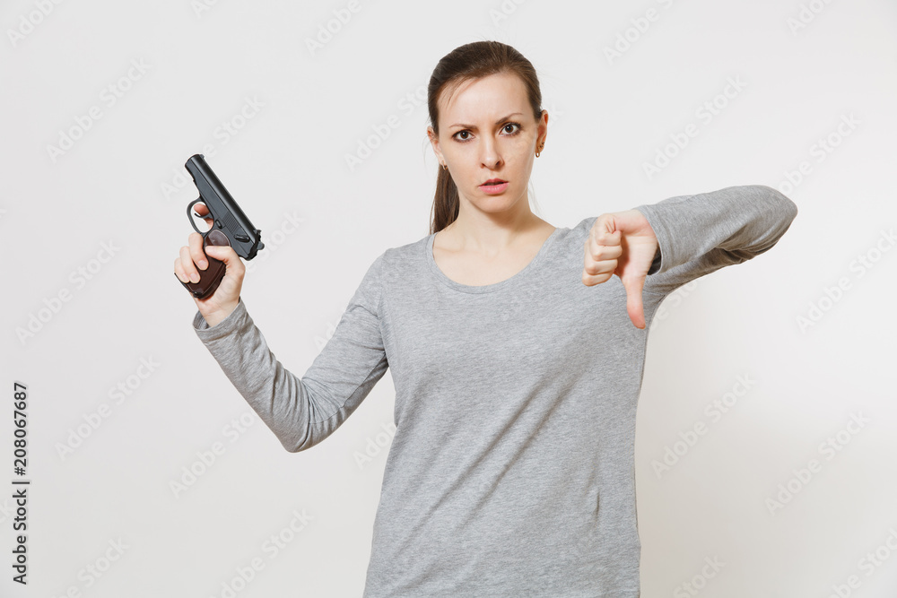 Woman with gun in hand showing thumbs down stop gesture isolated on white background. Girl hand no shooting symbol. Stop violence, weapons in school control, no killing people children problem concept Woman with gun in hand showing thumbs down stop gesture isolated on white background. Girl hand no shooting symbol. Stop violence, weapons in school control, no killing people children problem concept