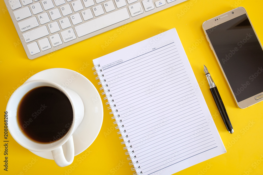 Flay lay of empty note book, computer keyboard, smartphone and coffee. Flay lay of empty note book, computer keyboard, smartphone and coffee.