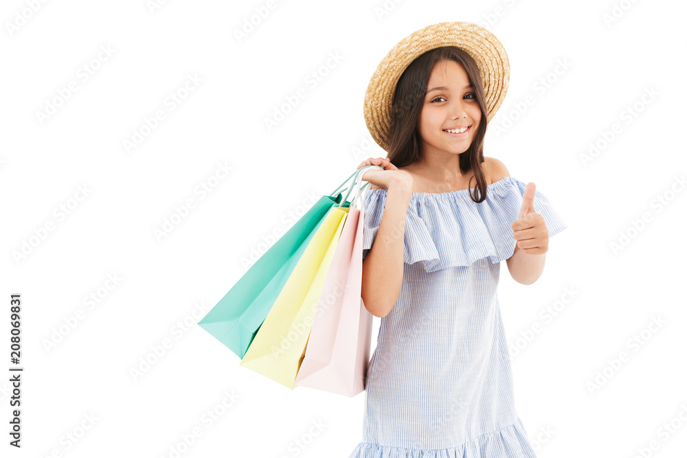 Cheerful young brunette girl in dress and straw hat posing Cheerful young brunette girl in dress and straw hat posing