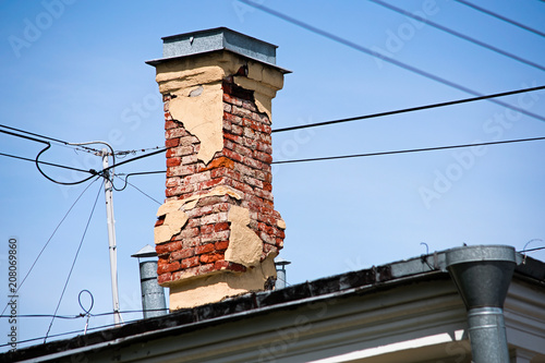 Tela Old brick chimney on the roof of the building