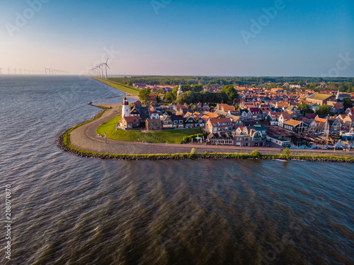Urk Netherlands a small village alongside the lake ijsselmeer Netherlands with the colorful lighthouse photo