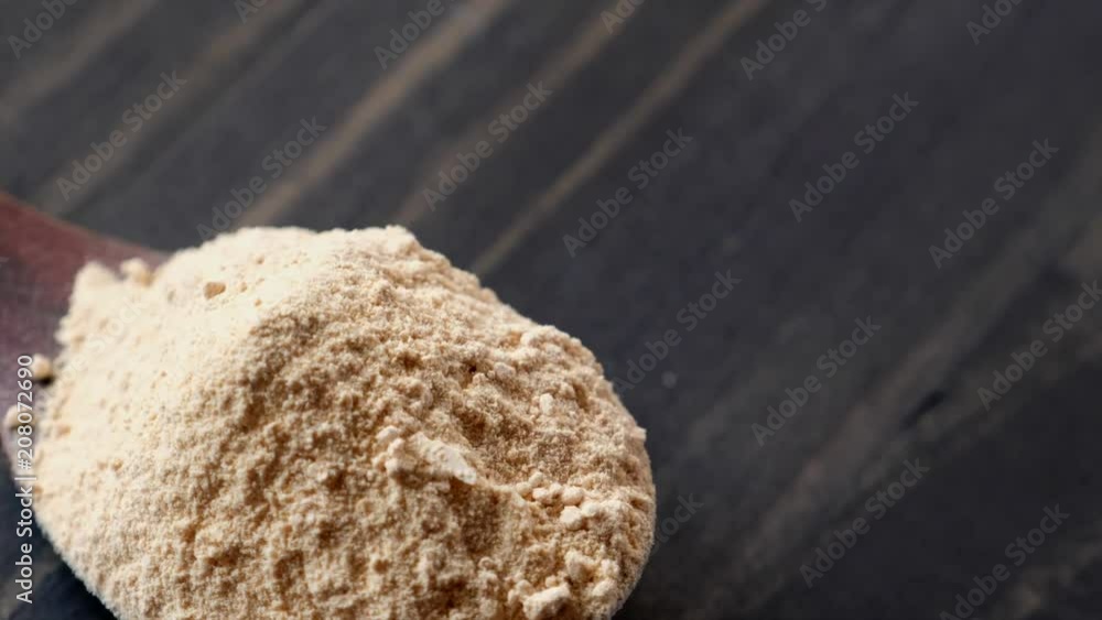 Superfood maca powder in wooden spoon rotating on wooden table top
Superfood maca powder in wooden spoon rotating on wooden table top