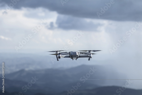 Fototapeta Naklejka Na Ścianę i Meble -  Drone quadrocopter with high resolution digital camera flying on the cloudy thunder sky