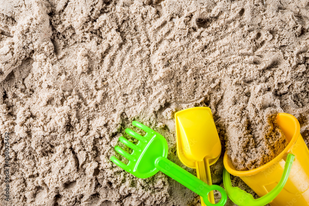 Summer vacation concept, Children's holidays background, sea sand and beach bright plastic toys, top view copy space Summer vacation concept, Children's holidays background, sea sand and beach bright plastic toys, top view copy space