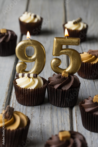Number 95 celebration birthday cupcakes on a wooden background