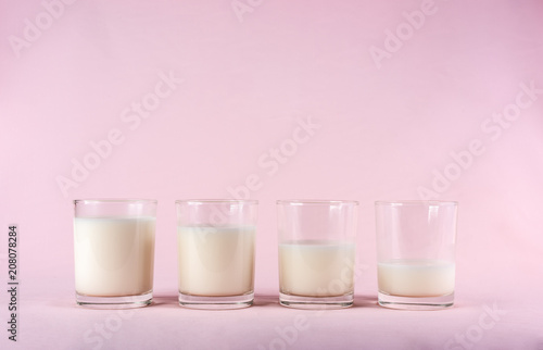 glass of milk show drinking stage on pink pastel background