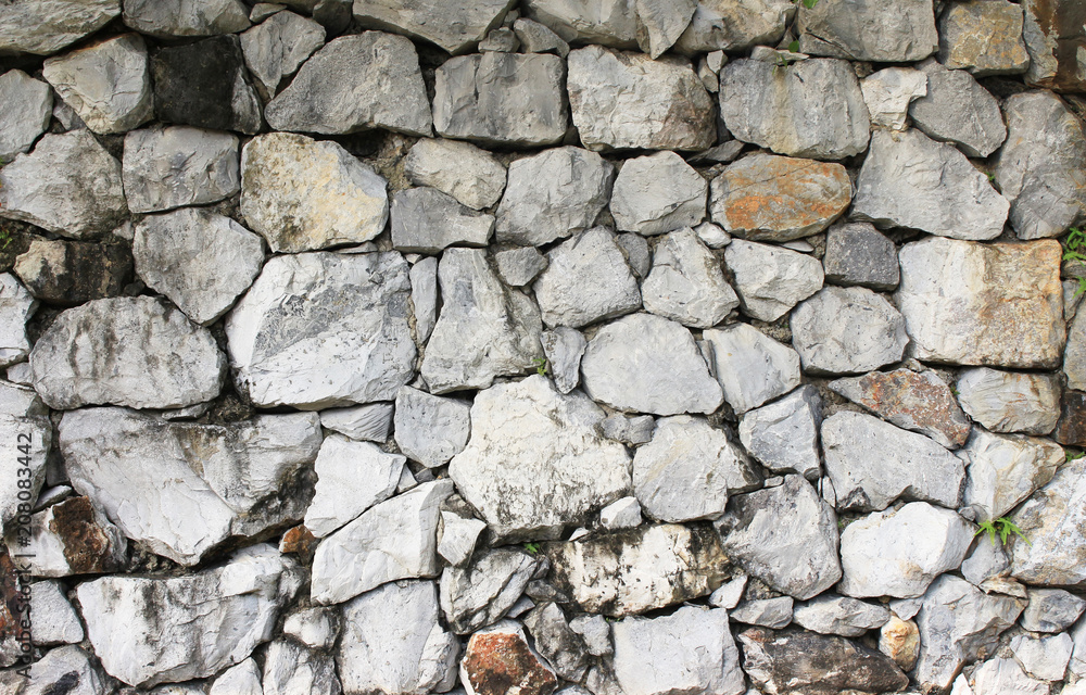 Fototapeta premium rough rock stone texture in the wall which is aged, grunge and dirty