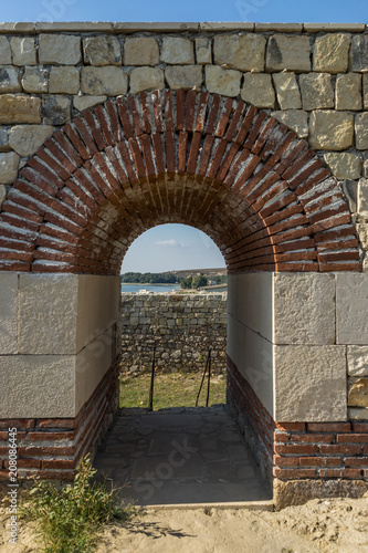 view through restored arch in a Roman fortress Cappidava on the banks of the Danube, Romania photo