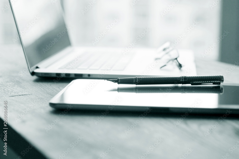 close up.fountain pen, tablet and laptop on the table.business background close up.fountain pen, tablet and laptop on the table.business background